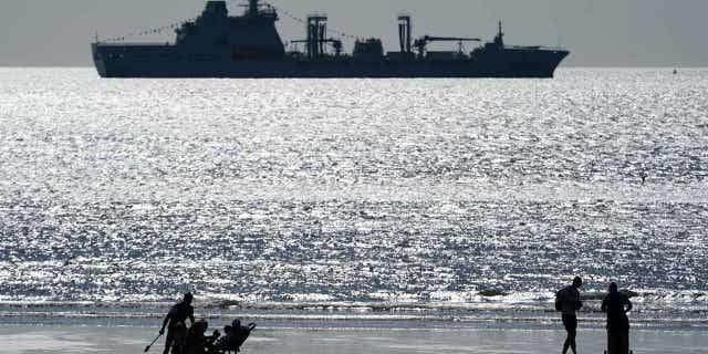 A Royal Fleet auxiliary tanker moves offshore during the National Armed Forces Day 2022 event on 25 June 2022. The UK sent a Royal Fleet auxiliary tanker with a helicopter to use as a platform for operations at Bahamas.