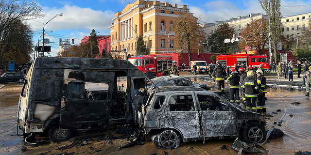 Rescuers examine the scene of a Russian attack in Kiev, Ukraine.