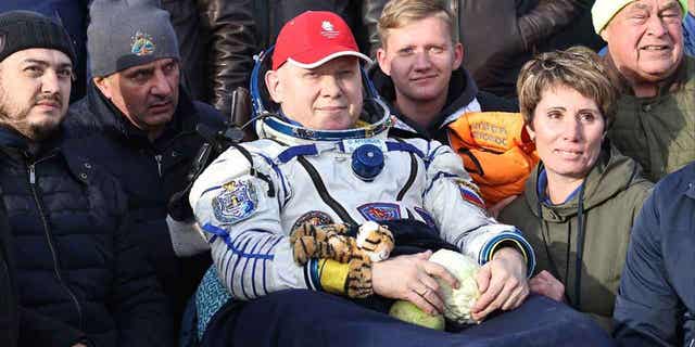 Russian cosmonaut Oleg Artemyev sits in a chair shortly after the landing of the Russian Soyuz MS-21 space capsule southeast of Zhezkazgan, Kazakhstan, on September 29, 2022. Artemyev drove a colleague on a dark road outside Moscow less than three weeks back from its last orbiting mission. 