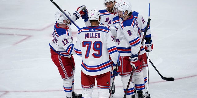 New York Rangers center Vincent Trocheck, top, celebrates with teammates after scoring a goal against the Minnesota Wild during the third period of a game Thursday, Oct. 13, 2022, in St. Paul, Minn.