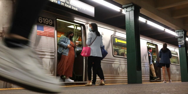 People wait for a subway ride at the West 4th Street Station in New York City on October 9, 2022. 