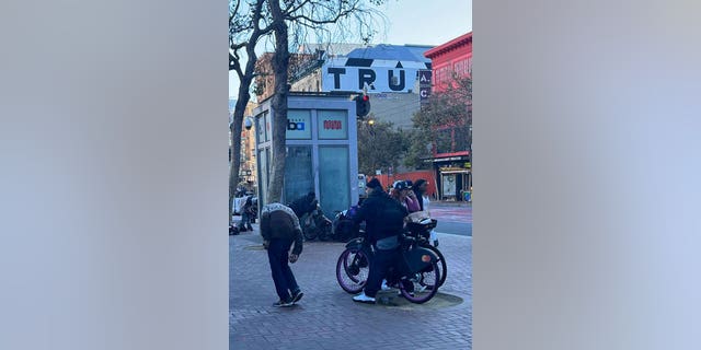 San Francisco bus stop crowded by homeless people.