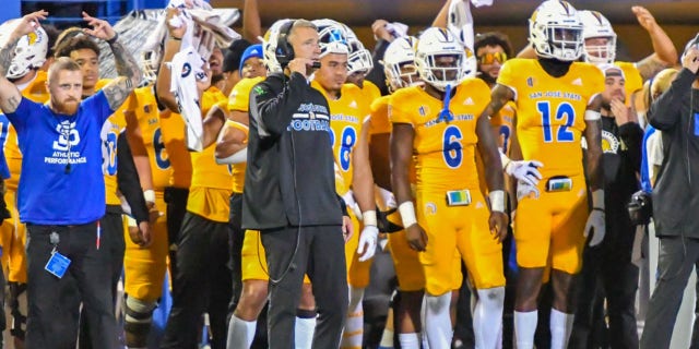 San Jose State Spartans head coach Brent Brennan talks to his staff on his headset during a game against the UNLV Rebels at CEFCU Stadium in San Jose, California, on Oct. 7, 2022.