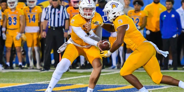 San Jose State Spartans turning their back Camden McCrite takes a handover from quarterback Chivan Cordero during a game against the UNLV Rebels at CFCU Stadium in San Jose, California, on October 7, 2022.