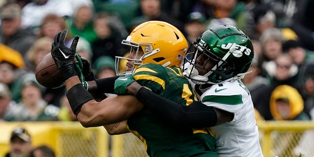 New York Jets cornerback Sauce Gardner, right, interferes with Green Bay Packers wide receiver Allen Lazard during the second half of an NFL football game Sunday, Oct. 16, 2022, in Green Bay, Wisconsin.