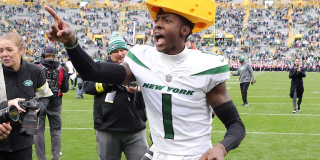 Sauce Gardner of the New York Jets celebrates by wearing a cheesehead after the Jets beat the Green Bay Packers at Lambeau Field on Oct. 16, 2022, in Green Bay, Wisconsin.