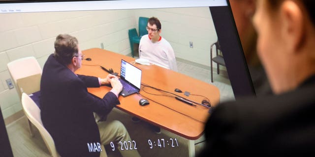 Marjory Stoneman Douglas High School shooter Nikolas Cruz is shown on a courtroom monitor during a videotaped interview with clinical neuropsychologist Dr. Robert L Denney as Dr. Denney testifies during the penalty phase of Cruz's trial at the Broward County Courthouse in Fort Lauderdale, Fla.,  on Thursday, Oct. 6, 2022. Cruz previously plead guilty to all 17 counts of premeditated murder and 17 counts of attempted murder in the 2018 shootings. (Amy Beth Bennett/South Florida Sun Sentinel via G3 Box News, Pool)