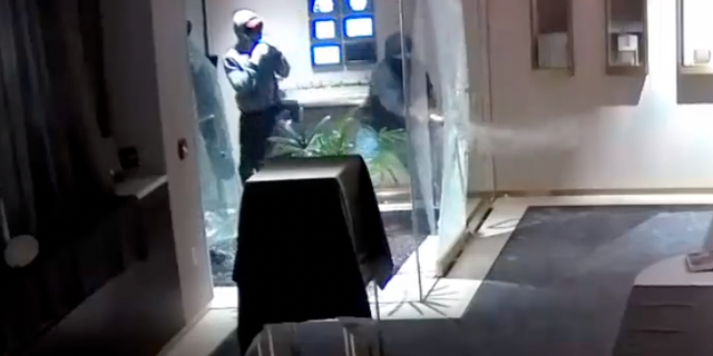 Three suspects used a sledgehammer to break through the glass doors at the front of the store. 