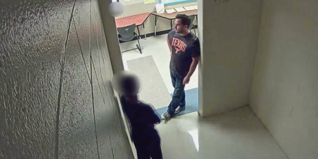 The student was standing in a hallway right before he attempted to leave. 
