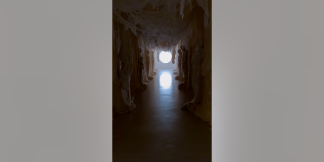 The SKIMS founder's hallway features rows of mummies.