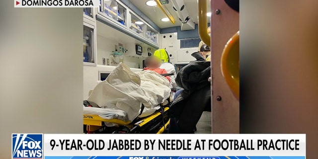 A 9-year-old boy outside Boston was jabbed with a drug needle during football practice when he fell to the ground during a warm-up lap.