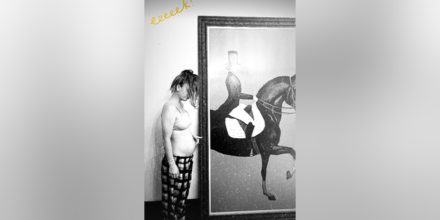 Kaley Cuoco shared a new picture, in which she looked down at her baby bump with sweet admiration.