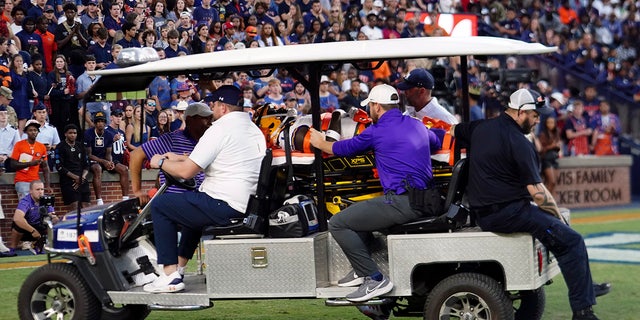 LSU's Sevyn Banks is transported to a waiting ambulance after being injured on the opening kickoff in the first half of an NCAA college football game against Auburn, Saturday, Oct. 1, 2022, in Auburn, Ala. 