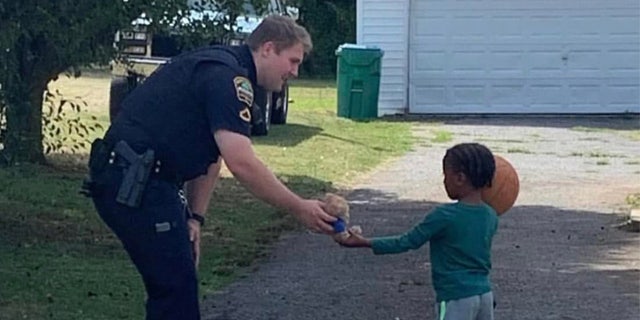 Spartanburg County Deputy Austin Aldridge is seen giving a stuffed animal to a child while on patrol. He was shot and killed in the line of duty June 21, 2022.