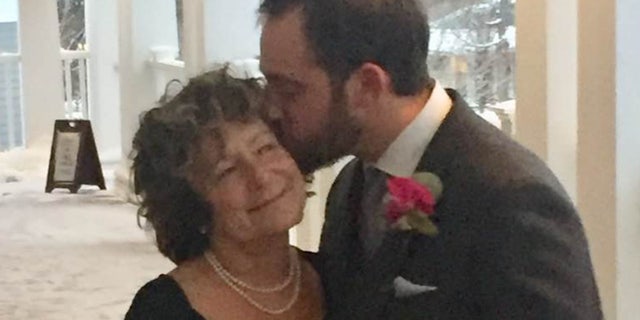 Adam Howe lovingly kisses his mom, Susan Howe, at his wedding in late 2019. He was arrested for her murder Friday, then died while in police custody.