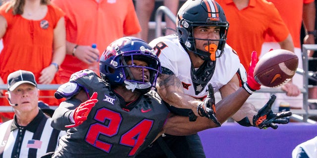 TCU cornerback Josh Newton (24) deflects a pass intended for Oklahoma State wide receiver Braydon Johnson (8) during the first half of a game in Fort Worth, Texas, Oct. 15, 2022.