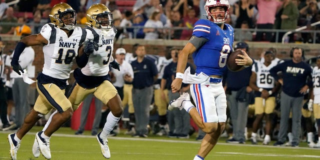 SMU quarterback Tanner Mordecai (8) rushes for a touchdown against Navy defender Rayuan Lane III (18) and Elias Larry (3) during the third quarter of an NCAA college football game in Dallas, Friday, Oct. 14, 2022.