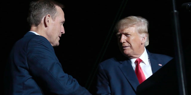 Former President Donald Trump, right, headlines a rally for Rep. Ted Budd, the Republican Senate nominee in North Carolina, on, Sept. 23, 2022, in Wilmington, N.C. (AP Photo/Chris Seward)