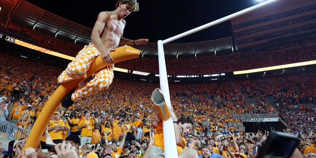 Volunteers fans tear down the goal post after Tennessee defeated the Alabama Crimson Tide at Neyland Stadium on Oct. 15, 2022, in Knoxville.