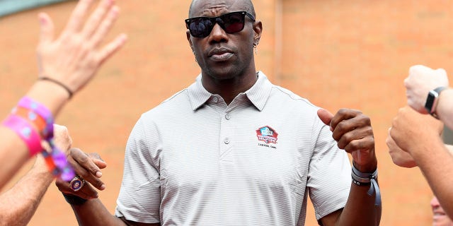 Hall of Fame wide receiver Terrell Owens celebrates with fans as he is unveiled ahead of the 2022 Pro Hall of Fame consecration ceremony at Tom Benson Hall of Fame Stadium on August 06, 2022 in Canton, Ohio.