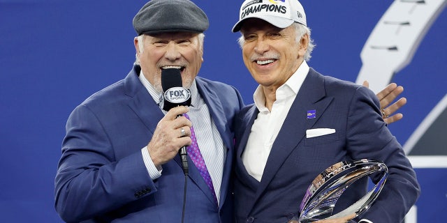 Los Angeles Rams owner Stan Kroenke speaks to Terry Bradshaw while holding the George Halas Trophy after defeating the San Francisco 49ers in the NFC championship game at SoFi Stadium Jan. 30, 2022, in Inglewood, Calif.
