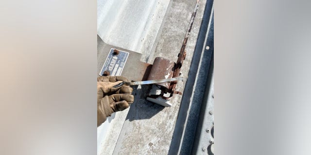 Border Patrol agents inspect a sealed grain hopper rail car.