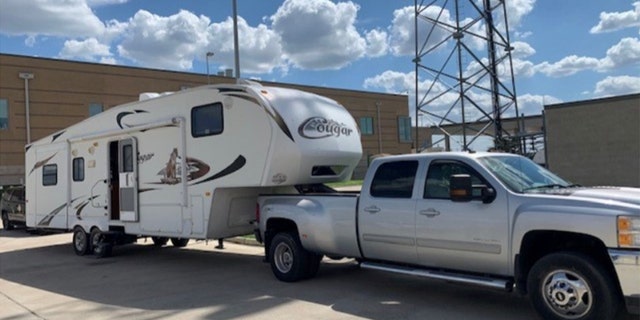 A 2014 Chevrolet pickup truck towing a Keystone travel trailer.