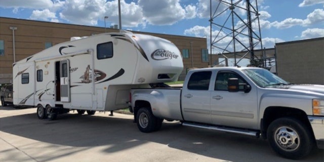 A 2014 Chevrolet pickup truck towing a Keystone travel trailer.