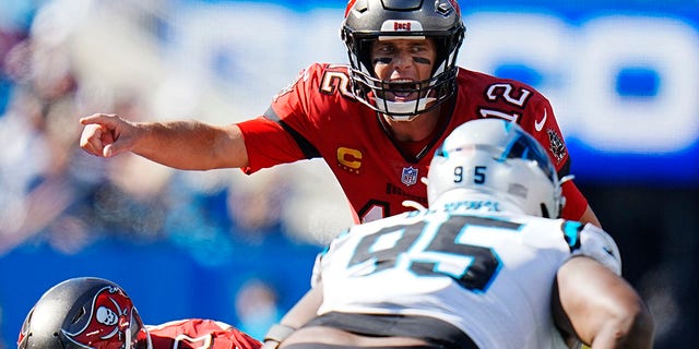 Tampa Bay Buccaneers quarterback Tom Brady, #12, directs his team during the second half of an NFL football game against the Carolina Panthers Sunday, Oct. 23, 2022, in Charlotte, North Carolina.