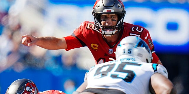 Tampa Bay Buccaneers quarterback Tom Brady (12) directs his team during the second half of an NFL football game against the Carolina Panthers Sunday, Oct. 23, 2022, in Charlotte, N.C.