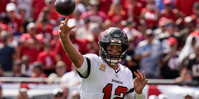 Buccaneers quarterback Tom Brady throws a touchdown pass to running back Leonard Fournette against the Atlanta Falcons on Sunday, Oct. 9, 2022 in Tampa, Florida.