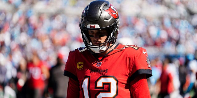 Tampa Bay Buccaneers quarterback Tom Brady, #12, walks off the field at halftime during the first half of an NFL football game against the Carolina Panthers on Sunday, Oct. 23, 2022, in Charlotte, North Carolina.