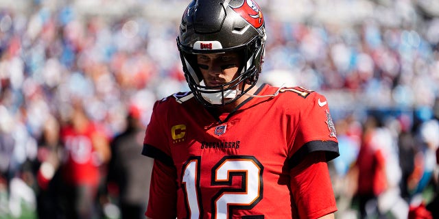 Tampa Bay Buccaneers quarterback Tom Brady, #12, walks off the field at halftime during the first half of an NFL football game against the Carolina Panthers on Sunday, Oct. 23, 2022, in Charlotte, North Carolina.