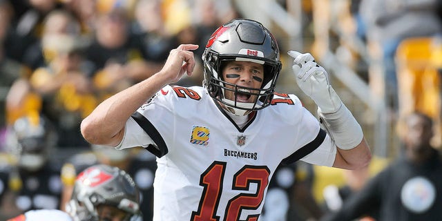 Tampa Bay Buccaneers quarterback Tom Brady (12) gives signals at the line of scrimmage during the first half of an NFL football game against the Pittsburgh Steelers in Pittsburgh, Sunday, Oct. 16, 2022.