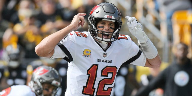 Tampa Bay Buccaneers quarterback Tom Brady (12) gives signals at the line of scrimmage during the first half of an NFL football game against the Pittsburgh Steelers in Pittsburgh, Sunday, Oct. 16, 2022.