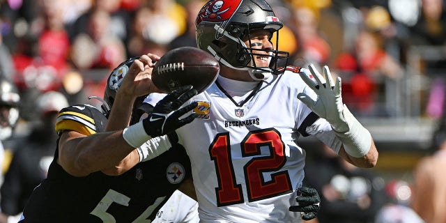 Pittsburgh Steelers quarterback Alex Highsmith, #56, imposes a fumble as he hits Tampa Bay Buccaneers quarterback Tom Brady, #12, during the first half of an NFL football game in Pittsburgh, Sunday, Oct. First 2022.