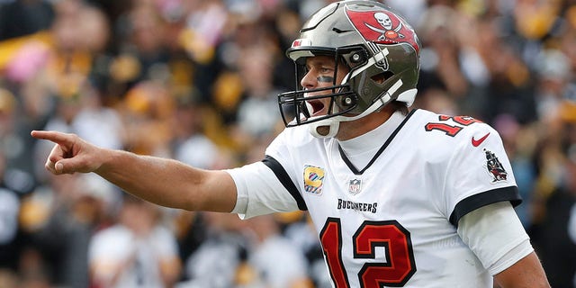 Tampa Bay Buccaneers quarterback Tom Brady, #12, gestures at the line of scrimmage against the Pittsburgh Steelers during the fourth quarter at Acrisure Stadium in Pittsburgh Oct. 16, 2022.