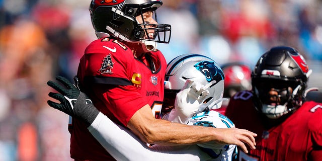 Panthers defensive end Yetur Gross-Matos pressures Tampa Bay Buccaneers quarterback Tom Brady after a pass, Sunday, Oct. 23, 2022, in Charlotte, North Carolina.