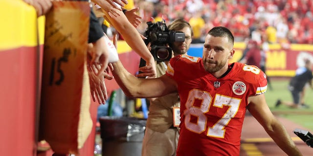 Kansas City Chiefs tight end Travis Kelce, #87, slaps hands with fans after an NFL game between the Los Angeles Chargers and Kansas City Chiefs on Sept. 15, 2022 at GEHA Field at Arrowhead Stadium in Kansas City, Missouri.