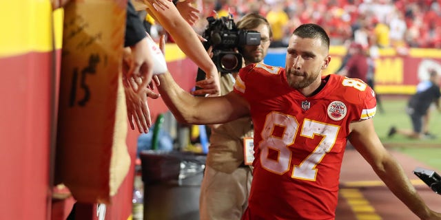 Kansas City Chiefs tight end Travis Kelce, #87, slaps hands with fans after an NFL game between the Los Angeles Chargers and Kansas City Chiefs on Sept. 15, 2022 at GEHA Field at Arrowhead Stadium in Kansas City, Missouri.