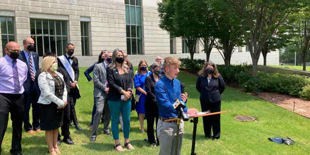 Dylan Brandt, above, speaks at a news conference outside the federal courthouse in Little Rock, Arkansas, on July 21, 2021. Brandt is among several transgender youth and families who are plaintiffs challenging a state law banning gender-confirming care for trans minors.