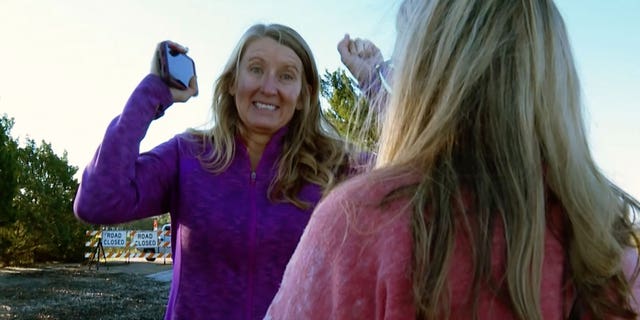 Mary Lord of Ft. Worth, Texas, mother of groom Eric Lord raises her hands hearing the news that some of the bridesmaids’ dresses, tuxedoes are being brought as A.J. McCullough of Sunset Beach, NC, mother of bride Monroe McCullough stands by on Saturday, Oct. 1, 2022, in Pawleys Island, South Carolina.