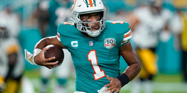 Miami Dolphins quarterback Tua Tagovailoa (1) runs the ball during the first half of an NFL football game against the Pittsburgh Steelers, Sunday, Oct. 23, 2022, in Miami Gardens, Fla.