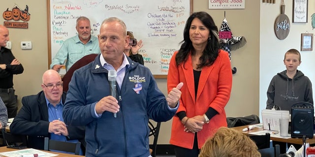 Former Rep. Tulsi Gabbard (right), a Democrat turned independent, campaigns with Republican Senate nominee in New Hampshire Don Bolduc (left), in Loudon, N.H. on Oct. 17, 2022