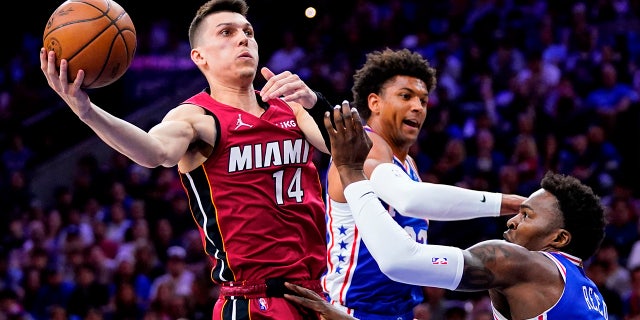 FILE - Miami Heat's Tyler Herro (14) goes up for a shot against Philadelphia 76ers' Matisse Thybulle, center, and Paul Reed during the first half of Game 6 of an NBA basketball second-round playoff series on May 12, 2022, in Philadelphia.
