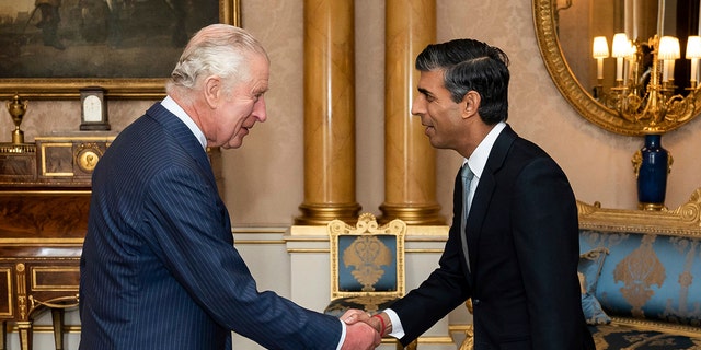 King Charles III greets Rishi Sunak during an audience at Buckingham Palace in London, where he invited the newly elected leader of the Conservative Party to become prime minister and form a new government.  25, 2022.