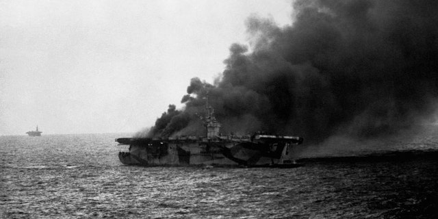 USS St Lo (CVE-63) burns after it's hit by Japanese suicide plane, Leyte Gulf, Phillipines. Close observation shows men going over the side. Oct. 25, 1944.
