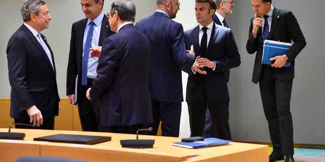 European Council President Charles Michel, center left, speaks with French President Emmanuel Macron, center right, during a round table meeting at an EU summit in Brussels, Friday, Oct. 21, 2022. (AP Photo/Geert Vanden Wijngaert)