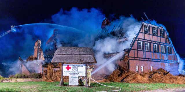 Firefighters extinguish a fire in a hotel where refugees from Ukraine were accommodated in Gross Stroemkendorf, Germany, on Oct. 20, 2022. The fire has almost completely destroyed the shelter on Thursday night.