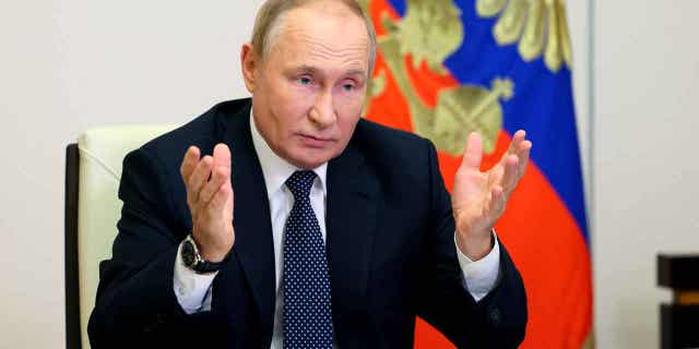 Russian President Vladimir Putin gestures during a meeting on Oct. 5, 2022. Putin, who turned 70 on Friday, received a tractor from the leader of Belarus for his birthday.
